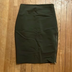 Express camo green pencil skirt with gold zipper detail on hip side.